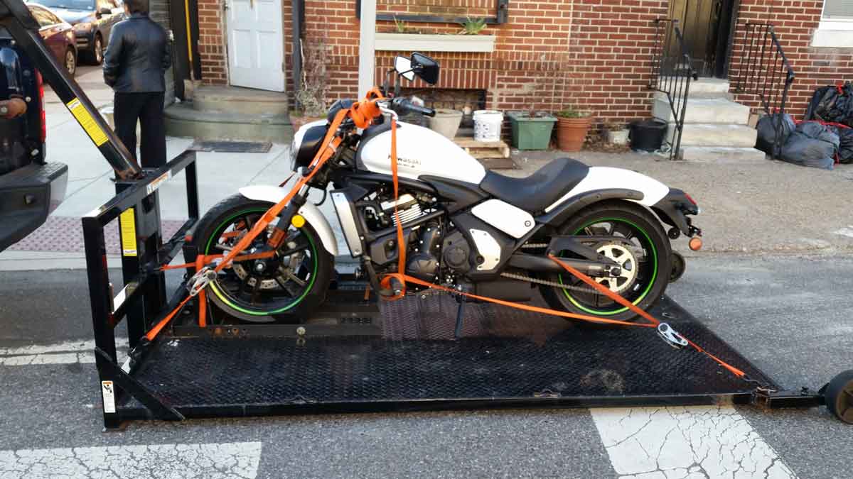 Motorcycle being safely loaded for towing